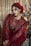 woman in red and white floral dress wearing red hat