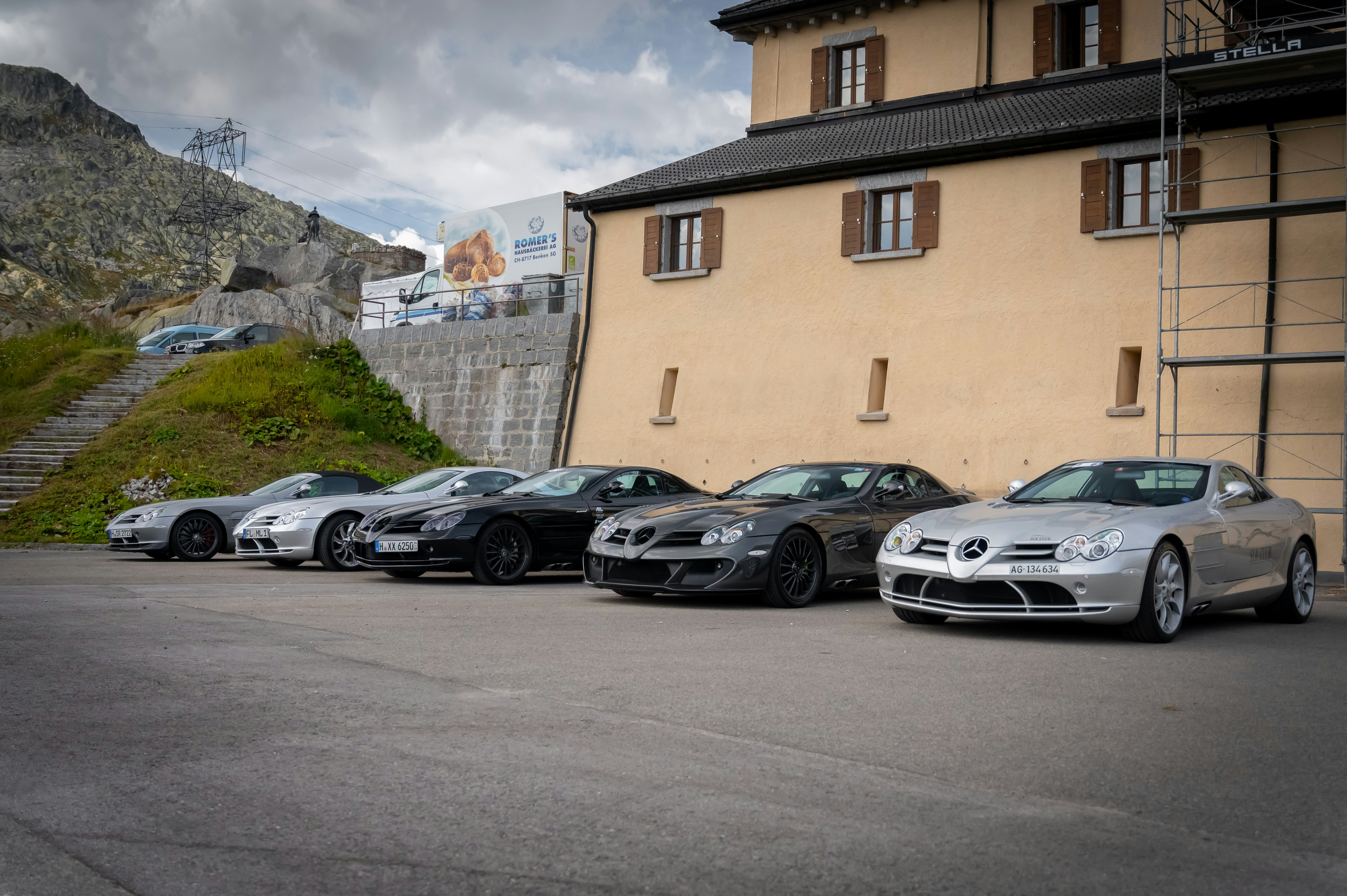 Several used electric cars from different brands lined up in a dealer row