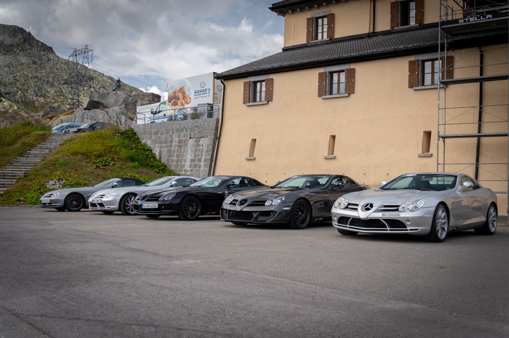 cars parked beside brown concrete building during daytime