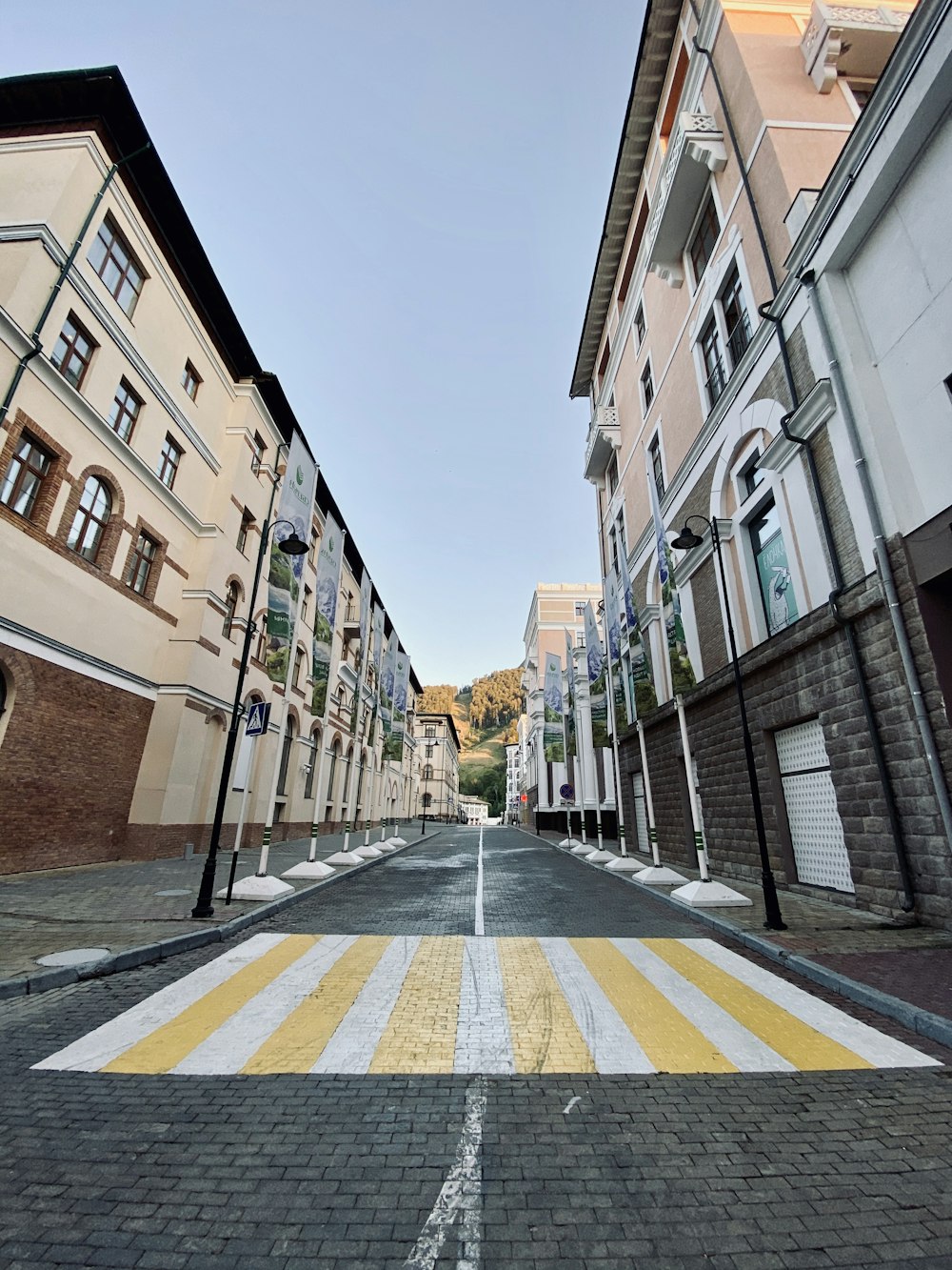 empty road between concrete buildings during daytime