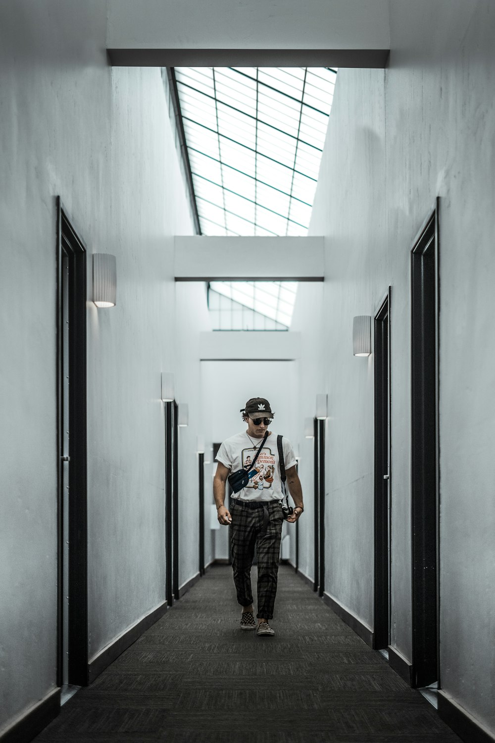 woman in black and white dress standing on hallway