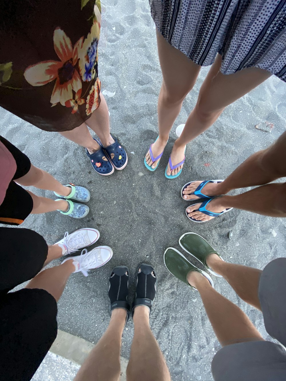 people standing on gray sand during daytime