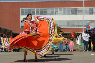 woman in red yellow and blue dress holding red and yellow textile