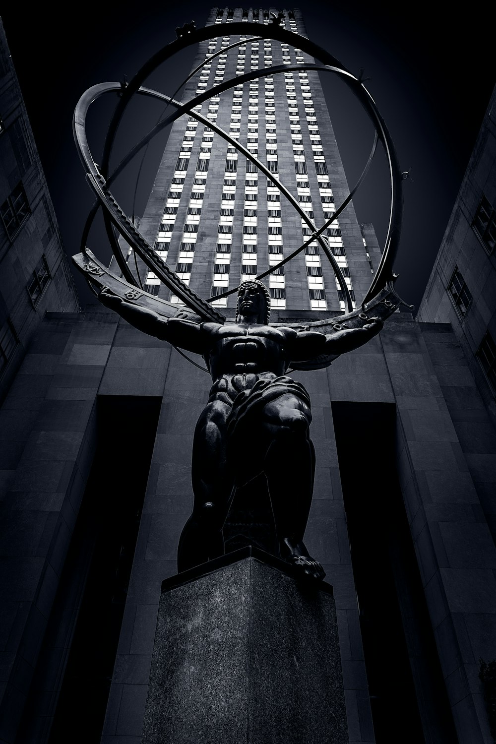 statue of man holding book