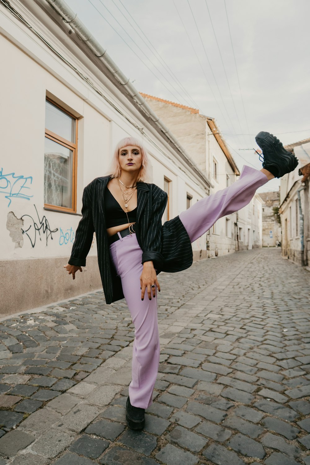 woman in black long sleeve shirt and pink pants holding man in black jacket