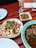 Close-up of a rustic wooden table with traditional Spanish tapas dishes.