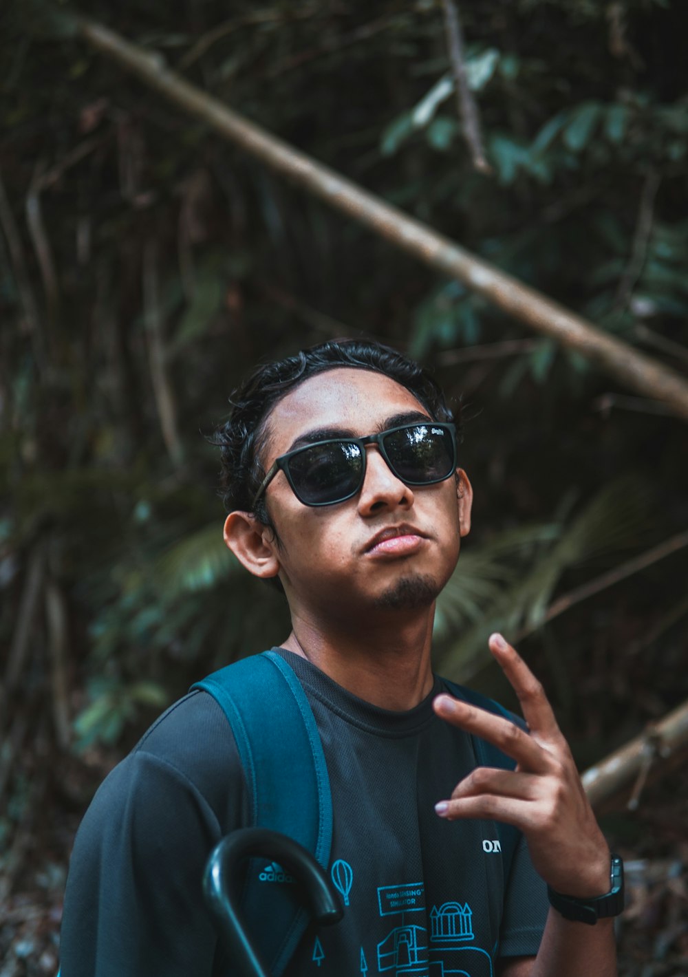 man in blue crew neck shirt wearing black sunglasses