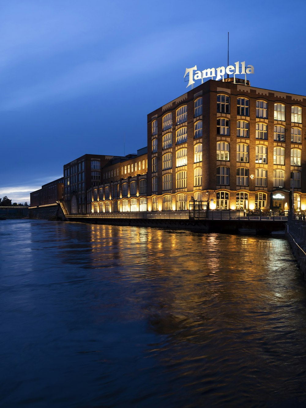 brown concrete building near body of water during night time