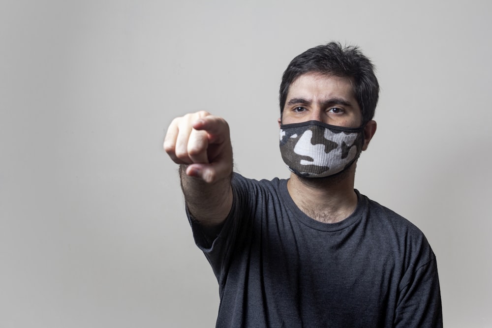 man in black crew neck shirt with black and white mask