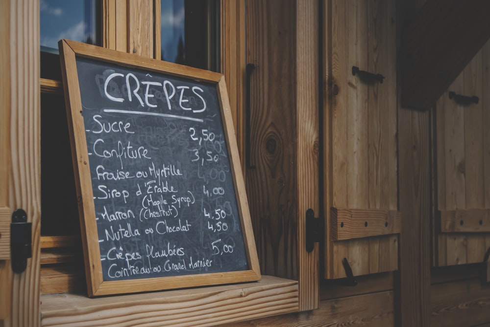 black chalk board on brown wooden wall