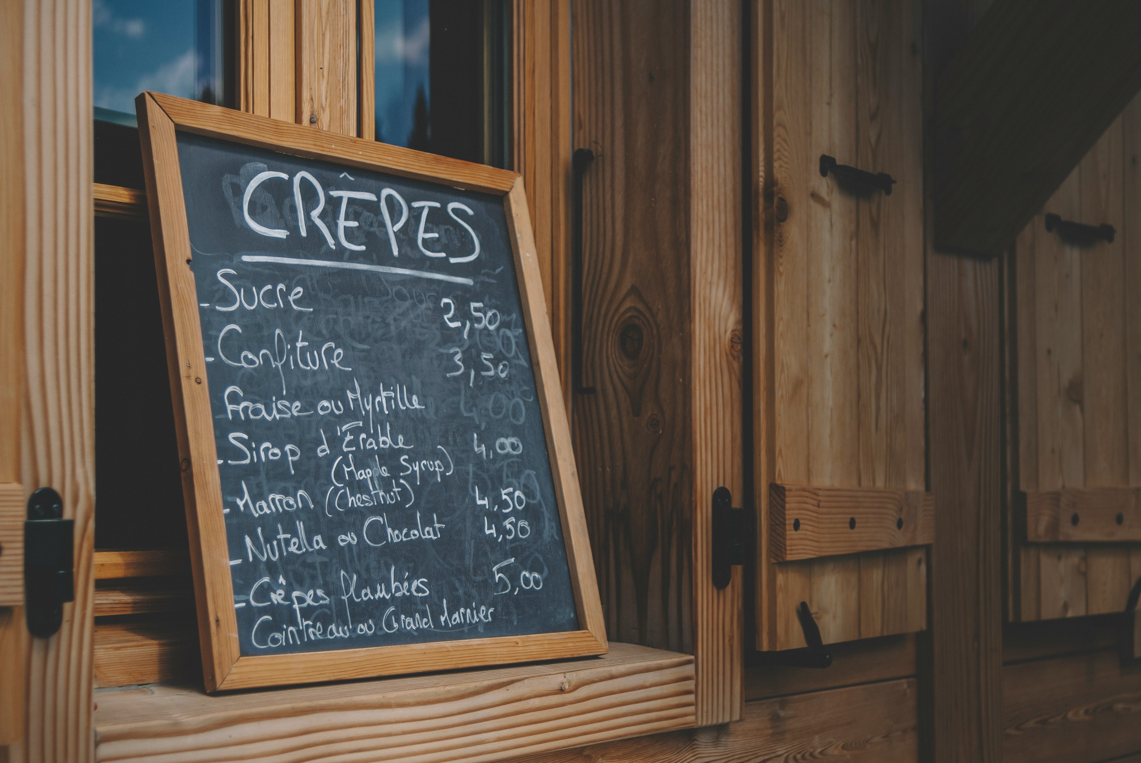 black chalk board on brown wooden wall