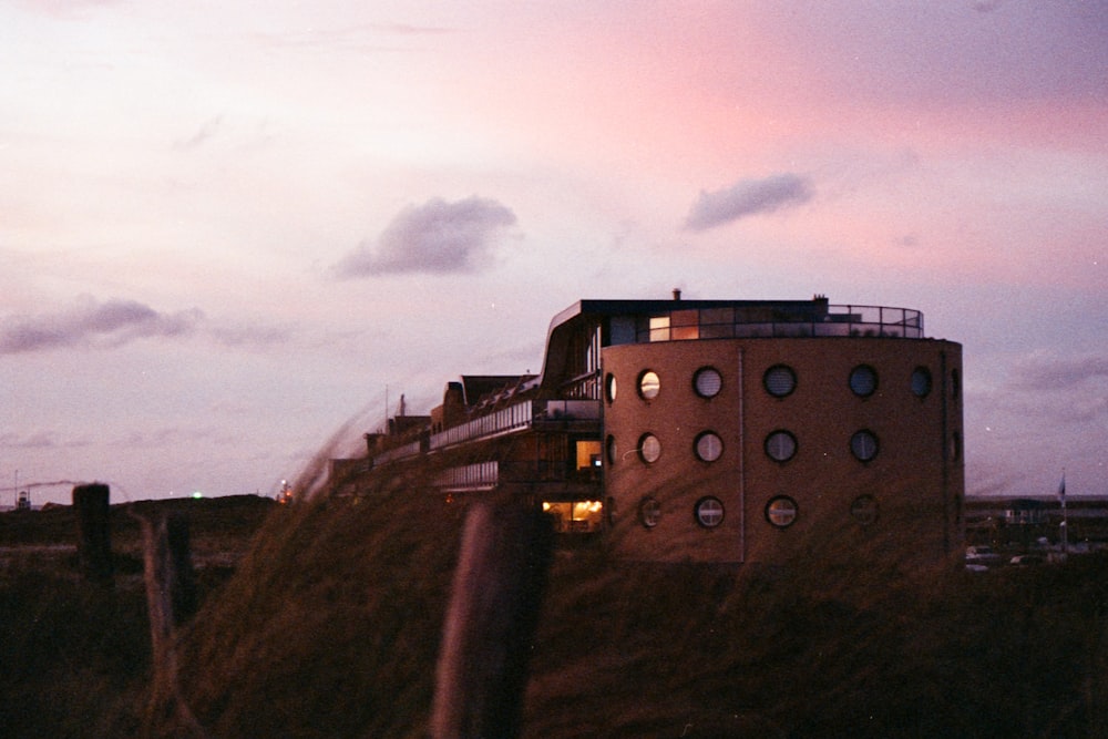 brown concrete building on top of hill