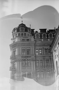 Black and white photo of a historic building facade with intricate architectural details.