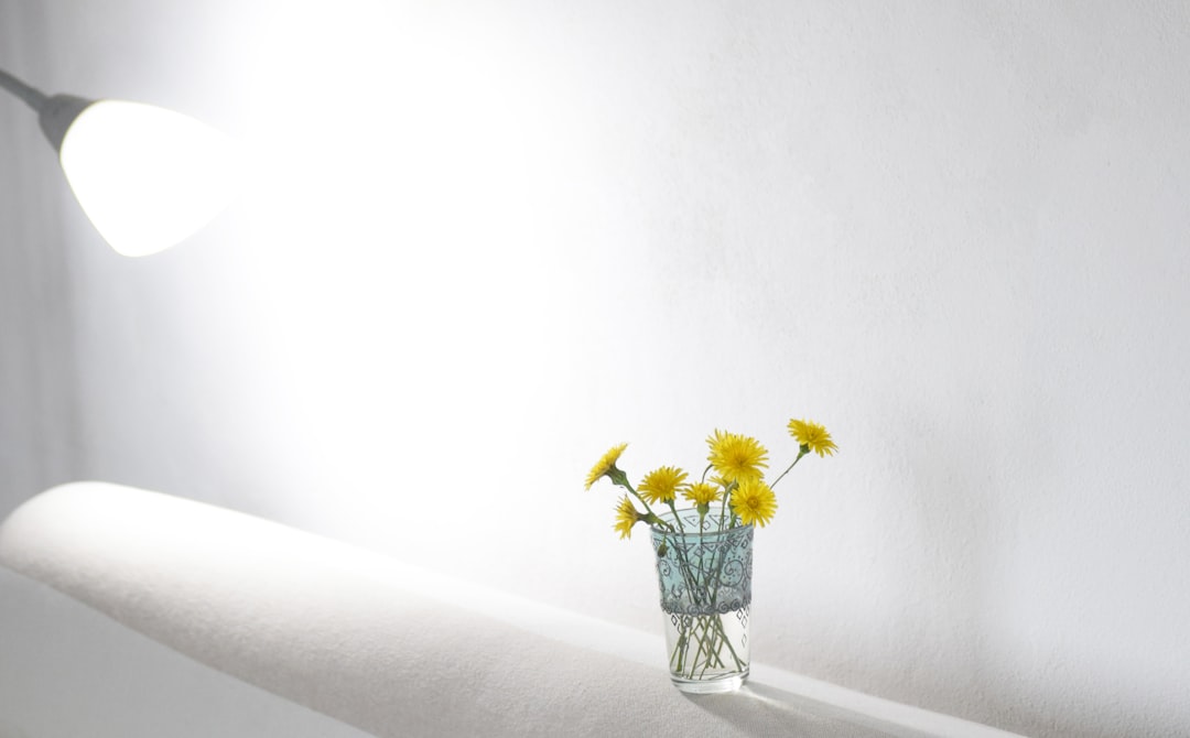 yellow flowers in clear glass vase