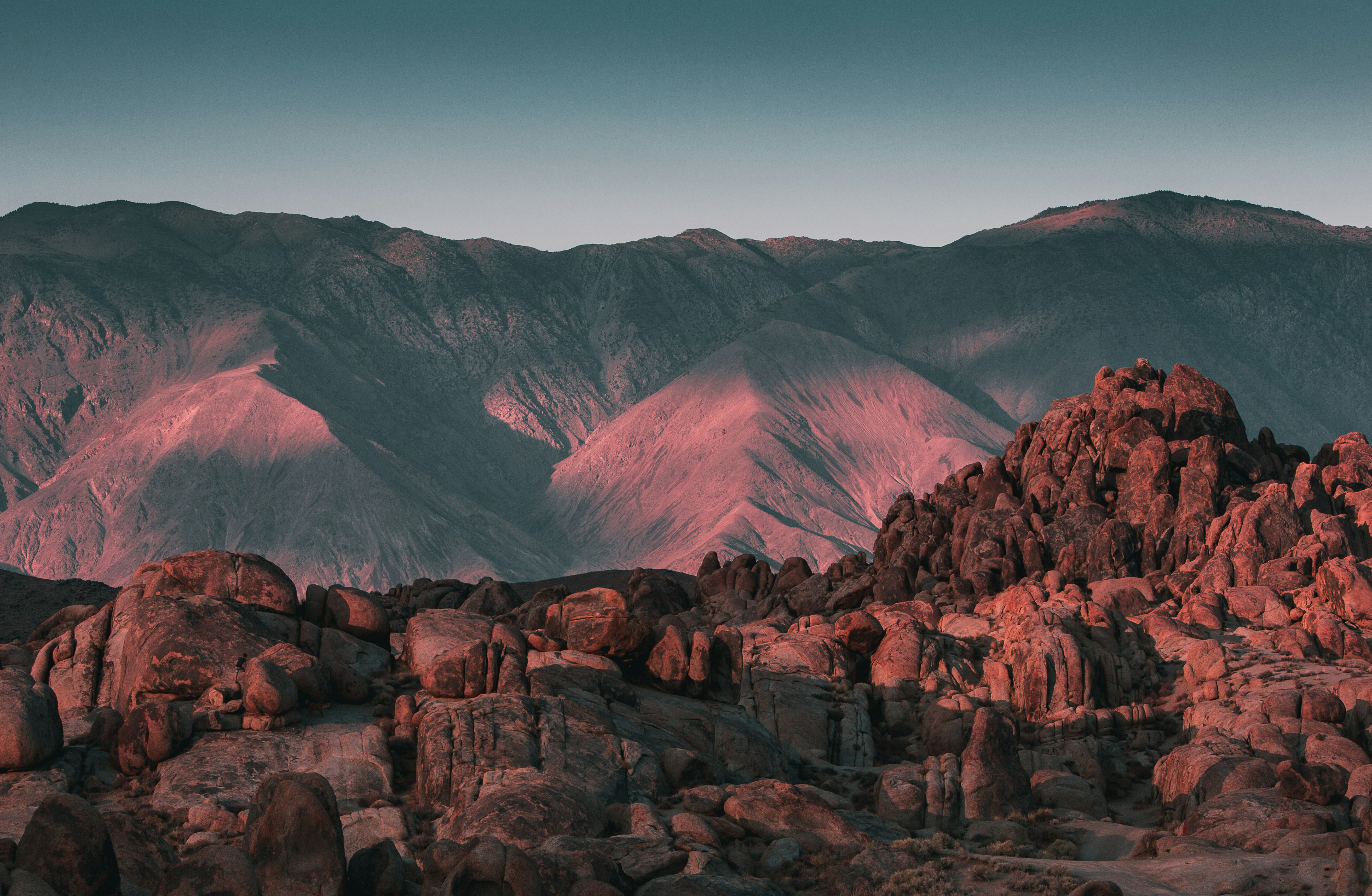 brown rocky mountain under blue sky during daytime, Golden Hour in Alabama Hills, Lone Pine, California. The rock formations come alive with the pink setting light.
