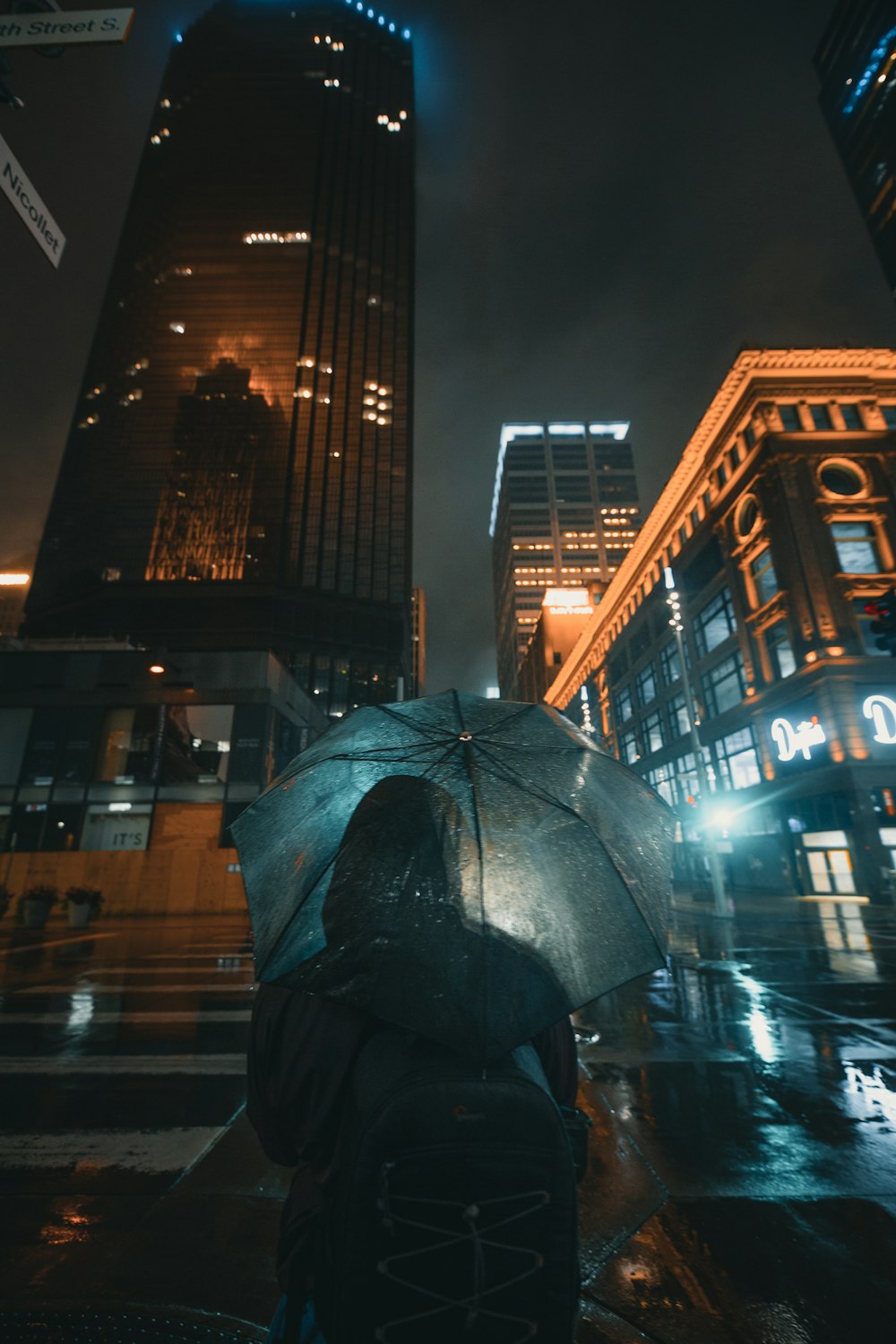 black umbrella near brown building during night time