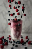 pink ice cream with red and blue berries on top