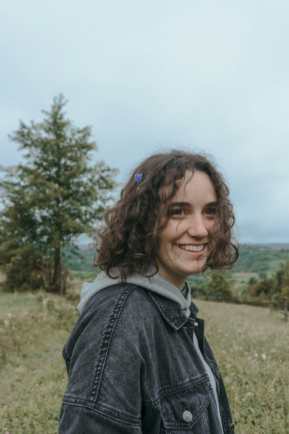 woman in blue denim jacket smiling