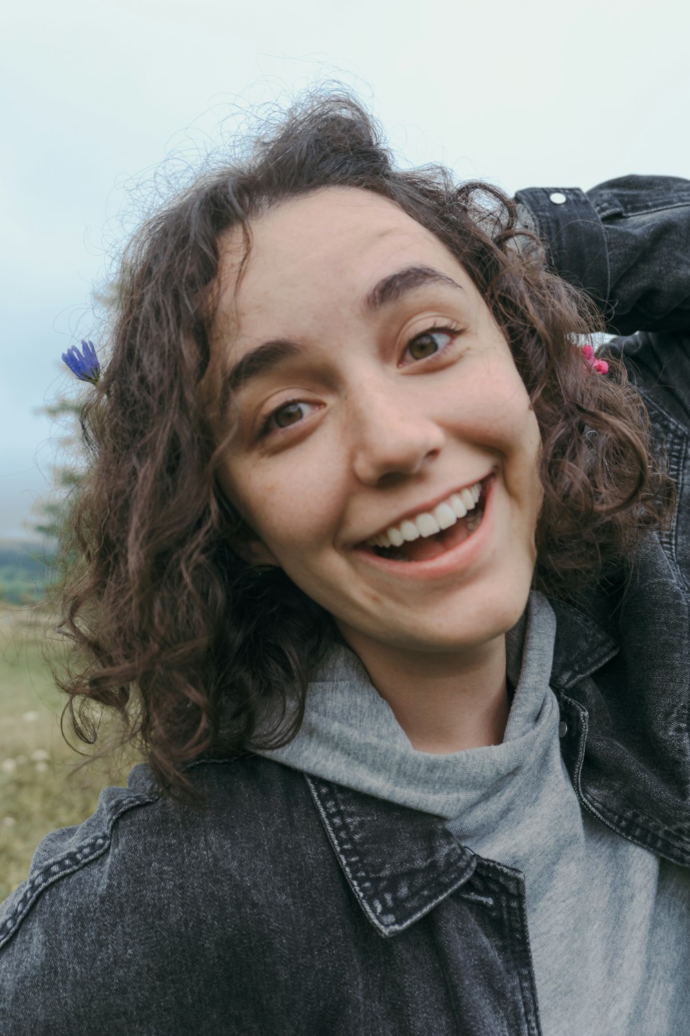 woman in gray zip up jacket smiling