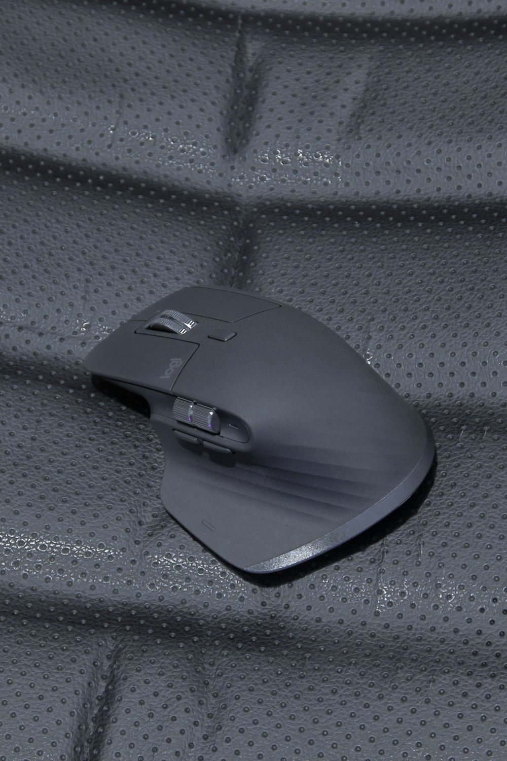 black cordless computer mouse on gray textile