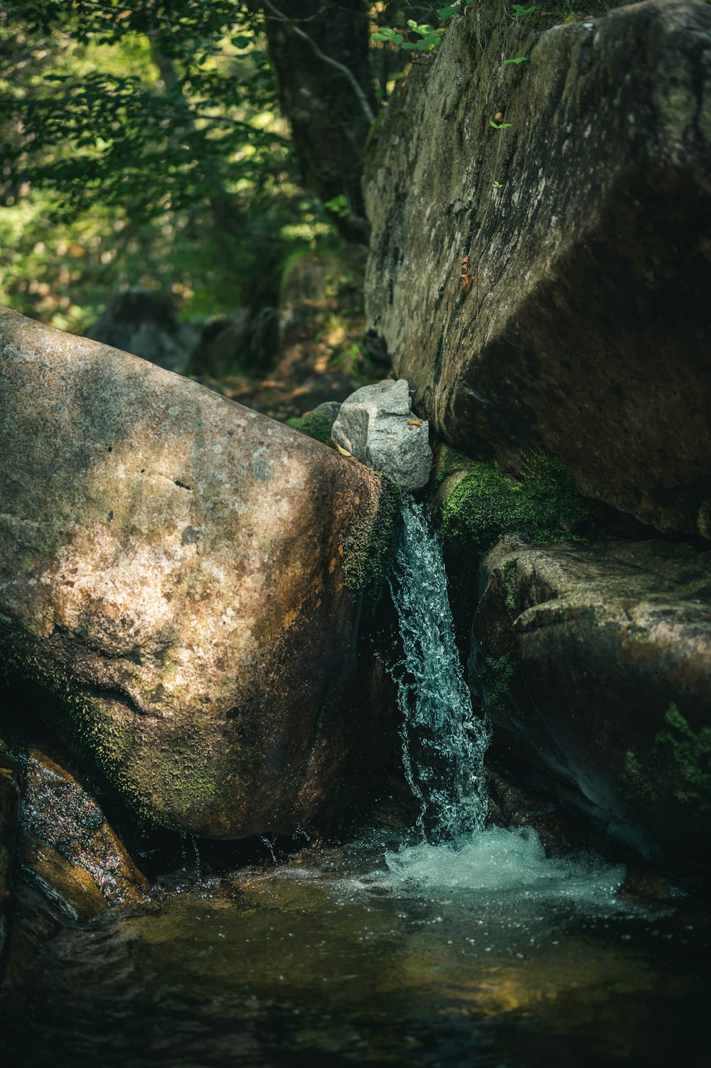 water falls on brown rock