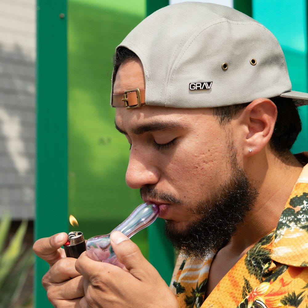 man in white fitted cap smoking cigarette