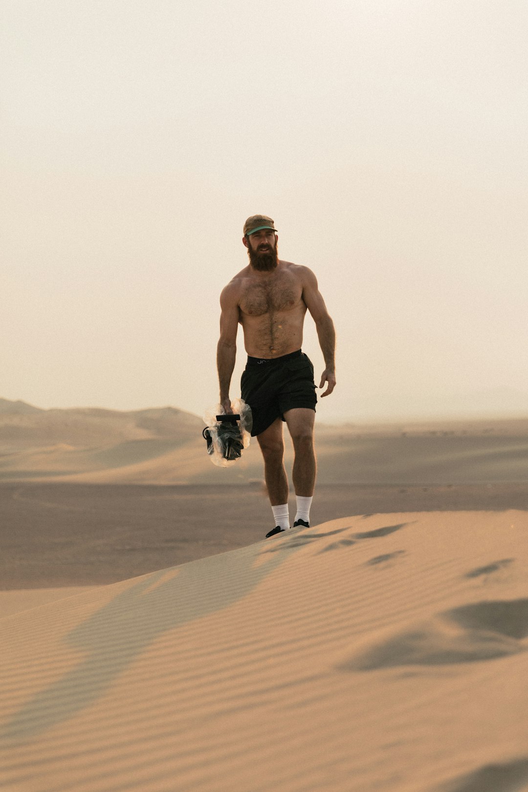 man in black shorts running on desert during daytime