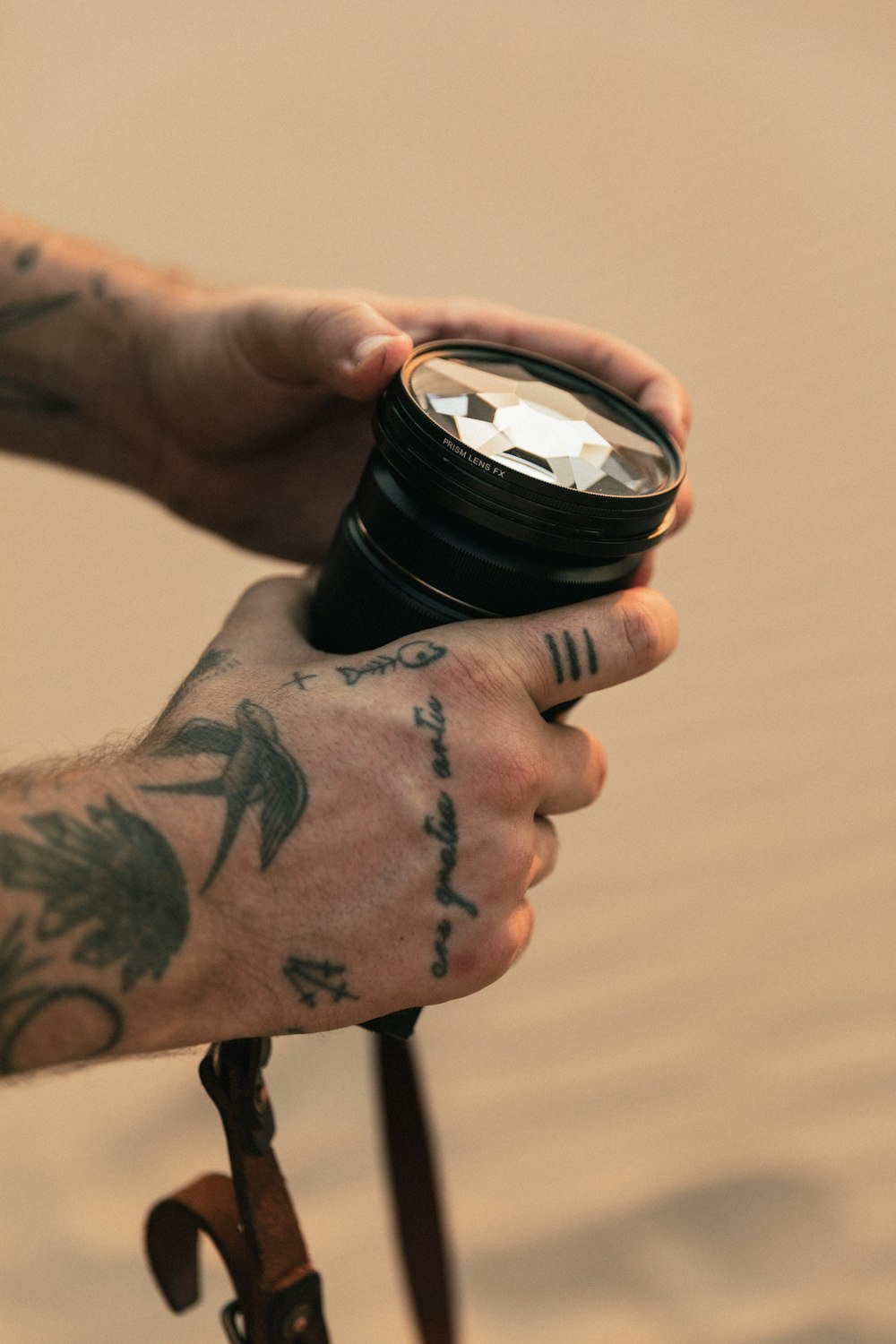 person holding black camera lens