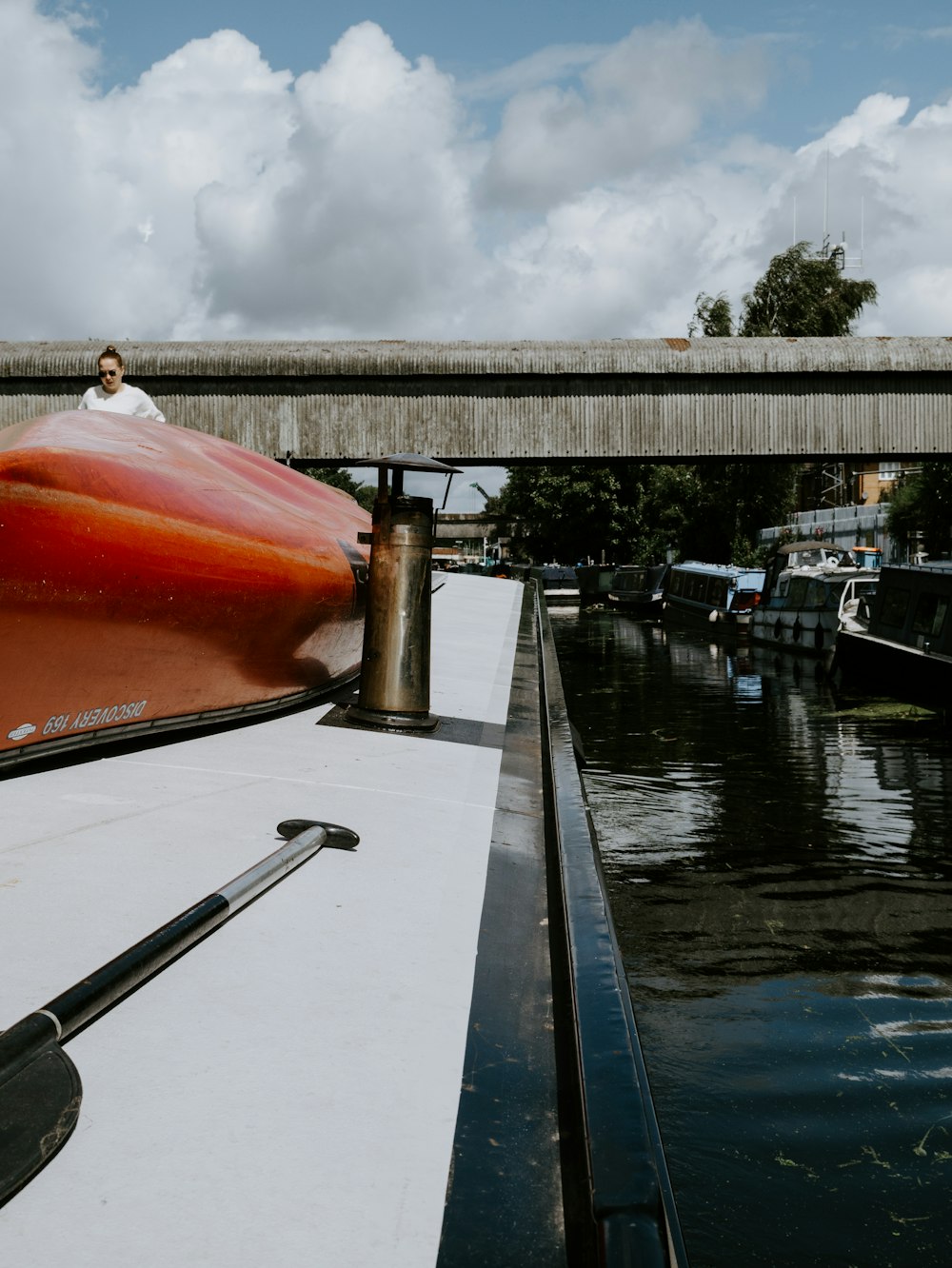 brown boat on water under gray cloudy sky during daytime