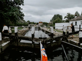 white and red flag on wooden dock during daytime