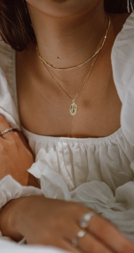 woman in white off shoulder dress wearing silver necklace