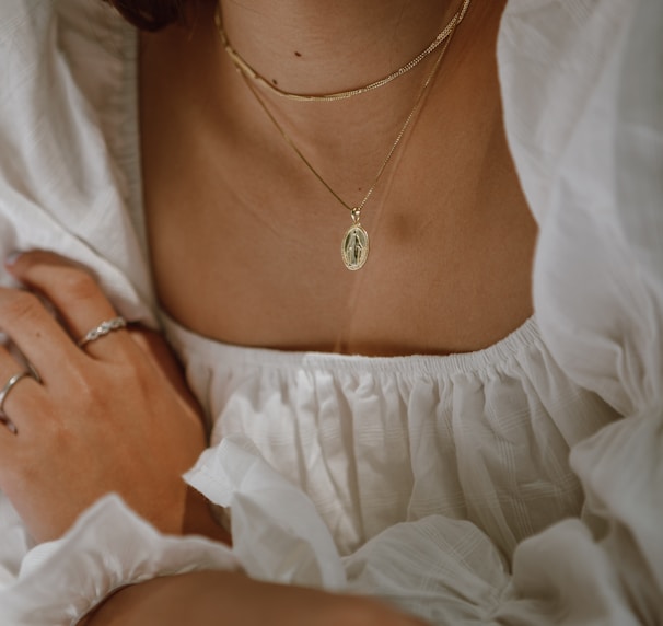 woman in white off shoulder dress wearing silver necklace