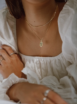 woman in white off shoulder dress wearing silver necklace