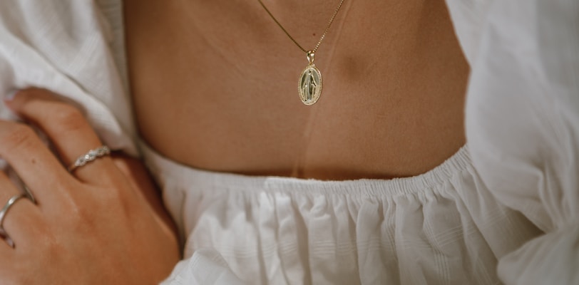 woman in white off shoulder dress wearing silver necklace