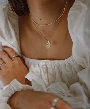 woman in white off shoulder dress wearing silver necklace