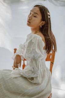 A flowy dress draped over a vintage chair with soft natural light