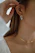 Close-up of a young woman wearing sleek silver hoop earrings and a minimalist necklace, styled with a casual streetwear outfit.