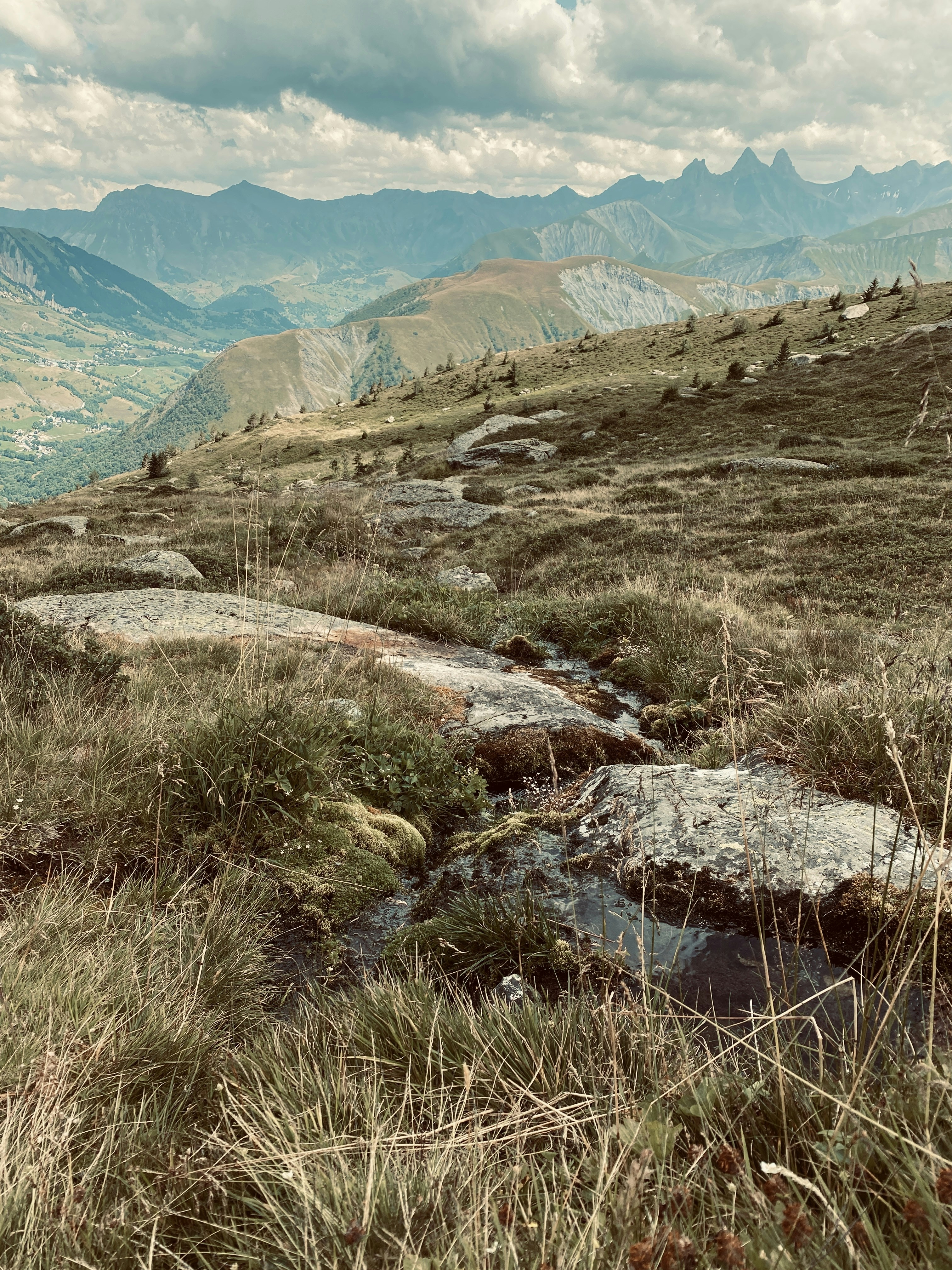 green grass field near mountains during daytime