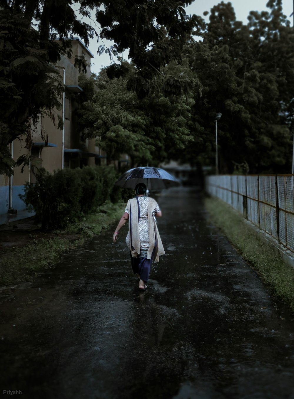 woman in white coat walking on pathway