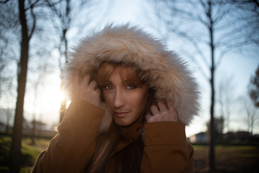 woman in brown fur lined coat