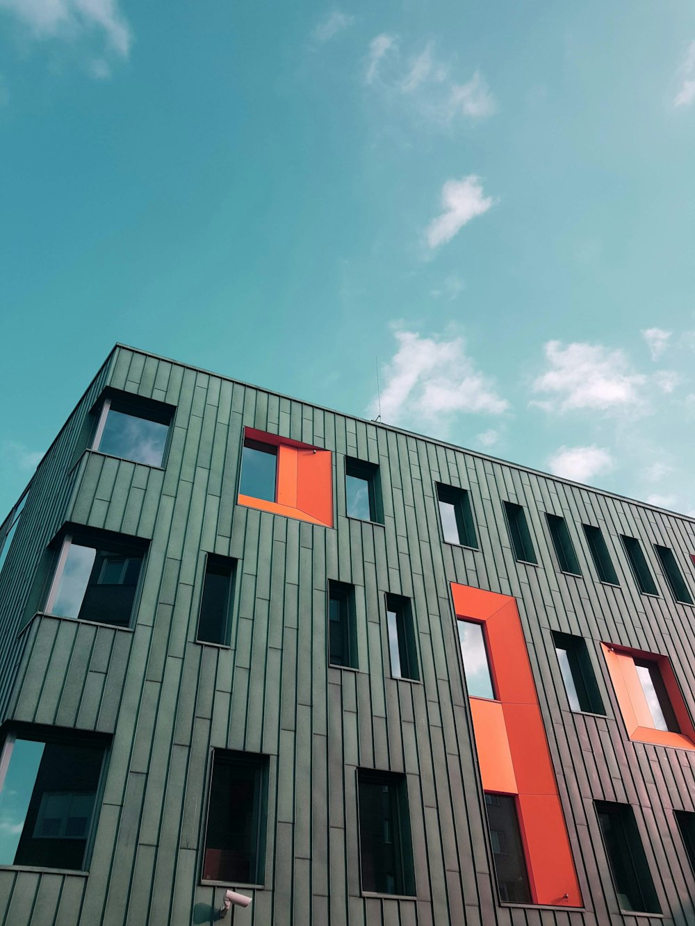 red and black concrete building under blue sky during daytime