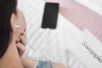 A happy customer handing over a used smartphone at a cozy home setting.