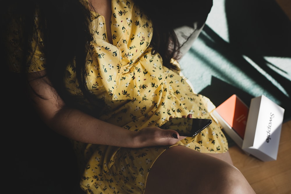 woman in yellow and white floral button up shirt