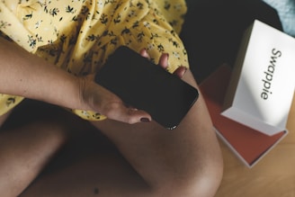A user happily packaging an item to send after a successful swap arranged through the app.