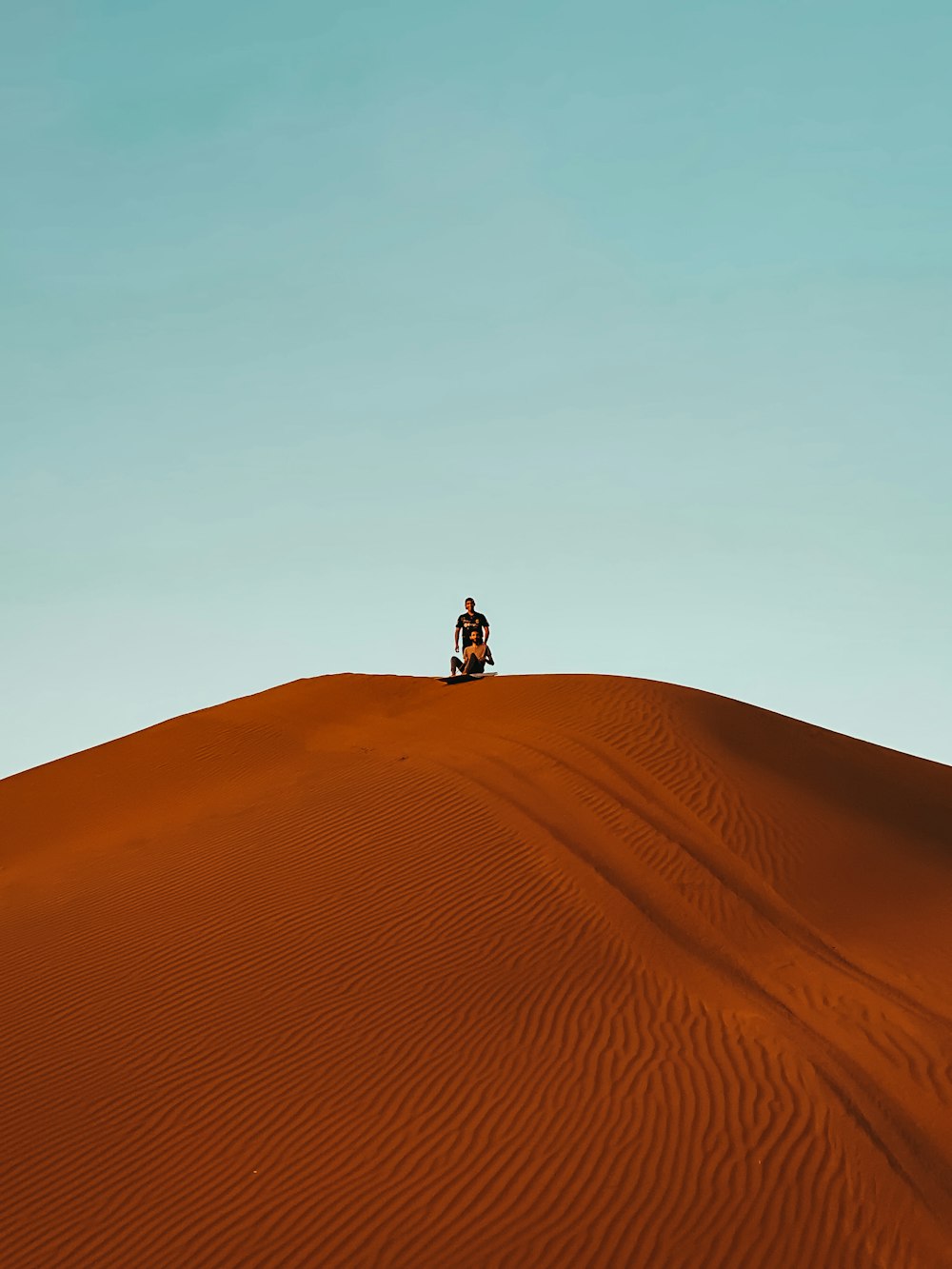 person standing on brown sand during daytime