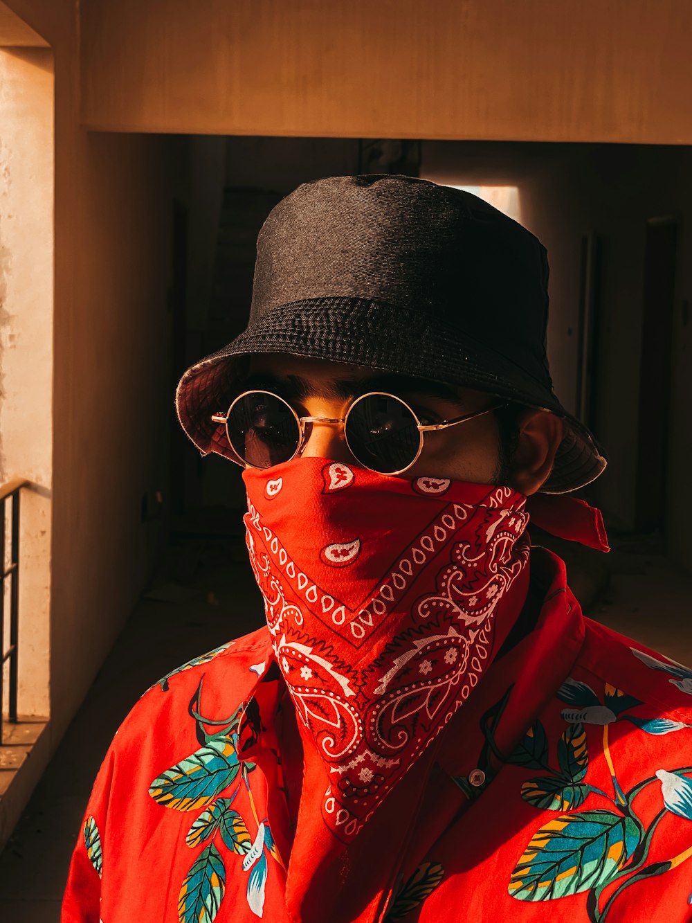 person in red and black scarf wearing black knit cap