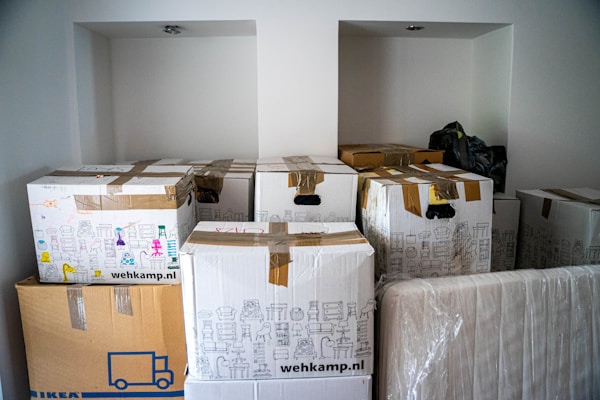 brown cardboard boxes on brown wooden tableby Michal B