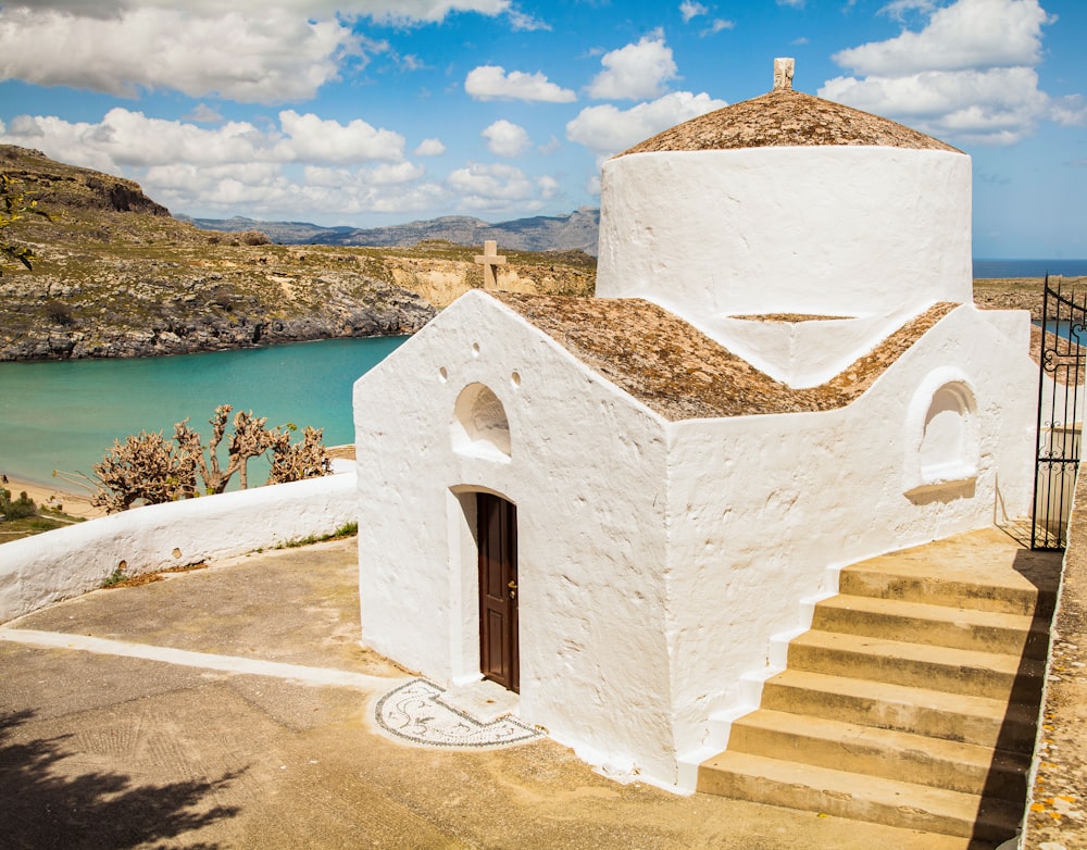 white concrete building near body of water during daytime