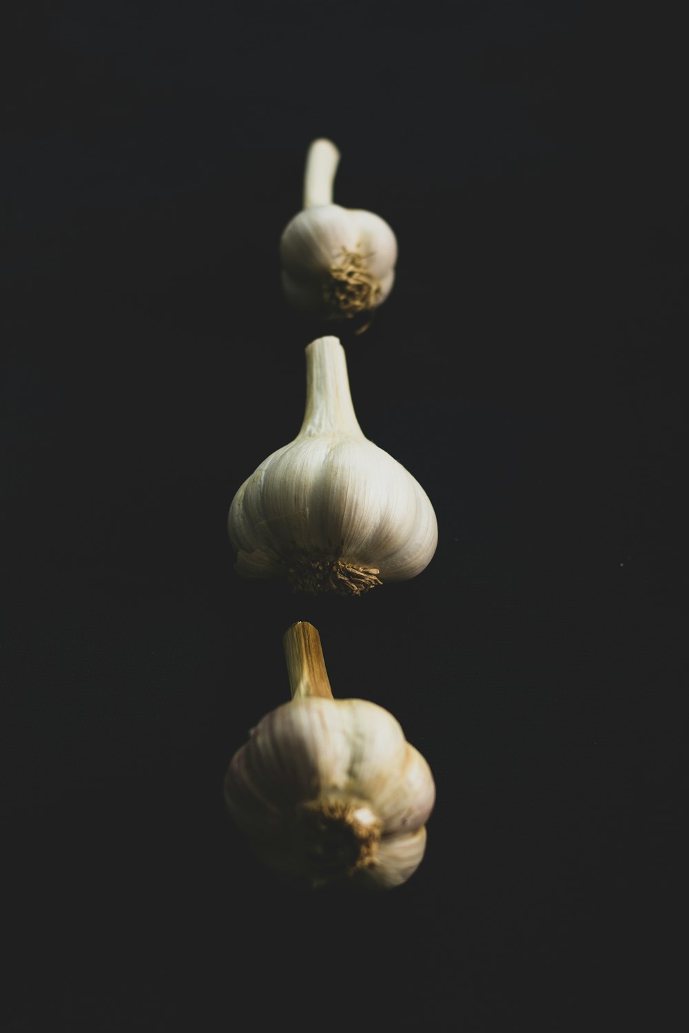 garlic bulb on black surface
