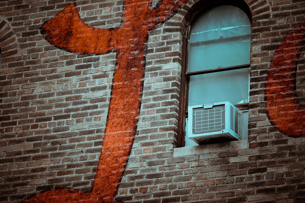 white wooden window frame on brown brick wall